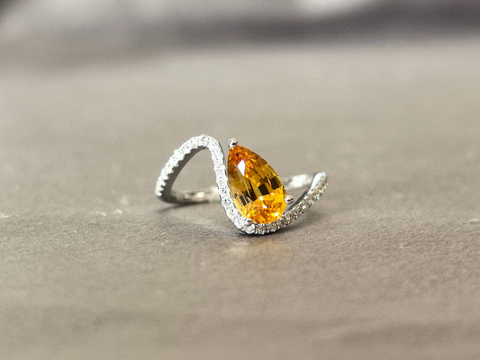 2-carat yellow pear-shaped lab-grown diamond pinky ring with small diamonds set on the band