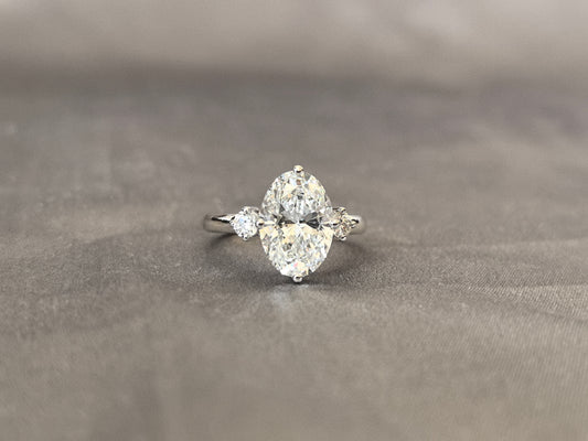 3 Carat Oval Lab Diamond Three-Stone Ring | Round Side Diamonds | 14K White Gold | Four-Claw Prong Setting | 2.2mm Band Width | Elegant Solitaire-Style Design