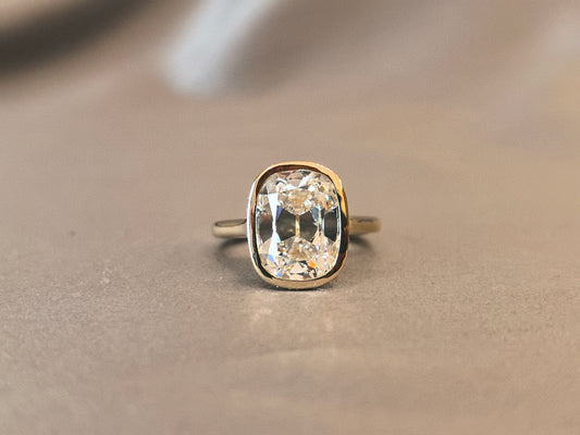 7-carat old mine cut elongated cushion bezel setting In 14K yellow gold