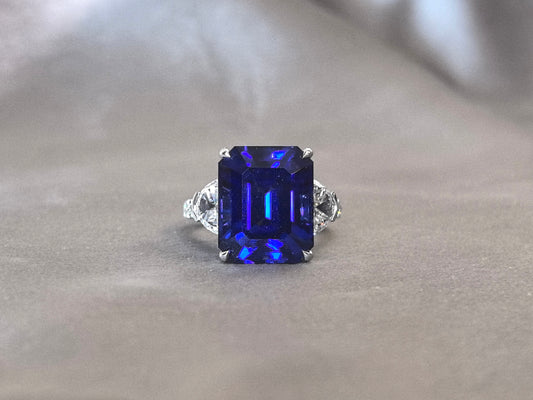 14.4ct 7.2g Emerald Cut Vivid Blue Sapphire Three-Stone Ring | Triangle Side Stones
