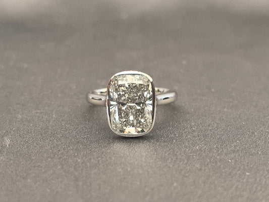 Long Cushion Cut Diamond Ring with a Pink Surprise
