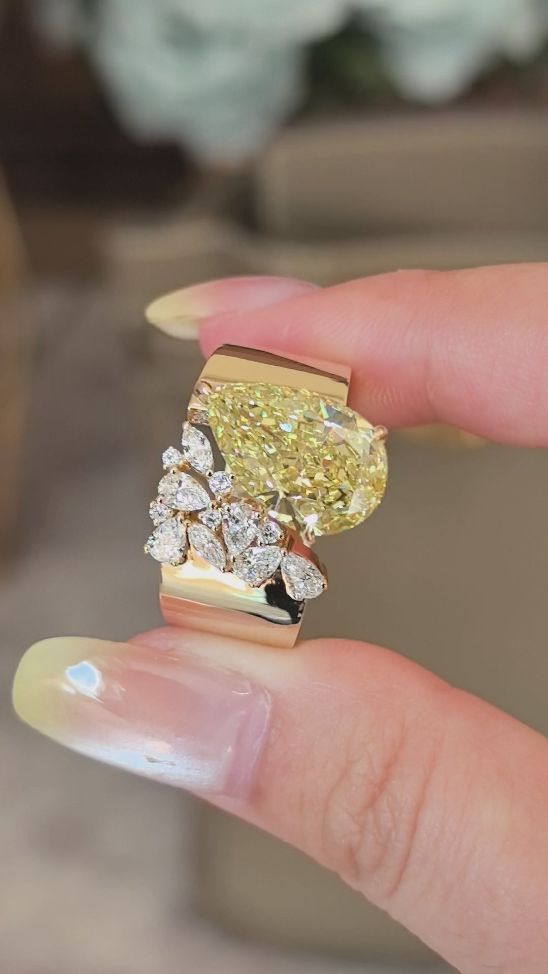 5.5-carat yellow diamond as the center stone | accompanied by pear-shaped, marquise, and round small diamonds | set on an ultra-wide band | surrounded by pavé-set small diamonds | spectacular and luxurious | 18k gold
