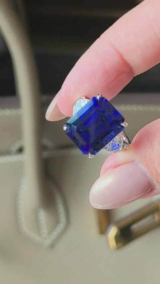 14.4ct 7.2g Emerald Cut Vivid Blue Sapphire Three-Stone Ring | Triangle Side Stones