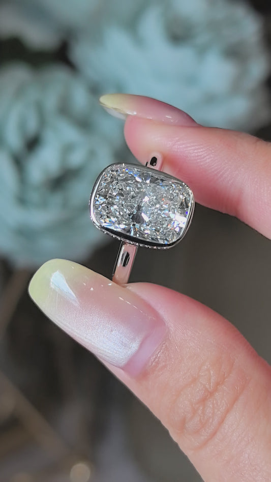 Long Cushion Cut Diamond Ring with a Pink Surprise